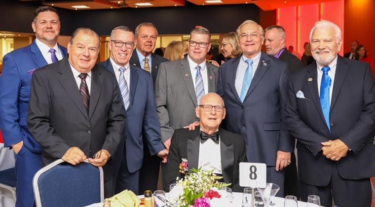 Colonel George H. Chabbott (seated), honorary chair of the 2022 Gourmet Gala, enjoys the evening with friends.